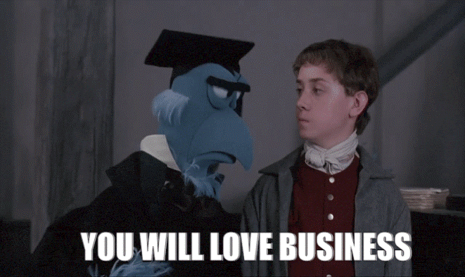 Muppet with graduation hat talking to a boy