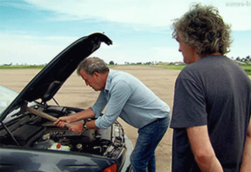 two mens man fixing a car