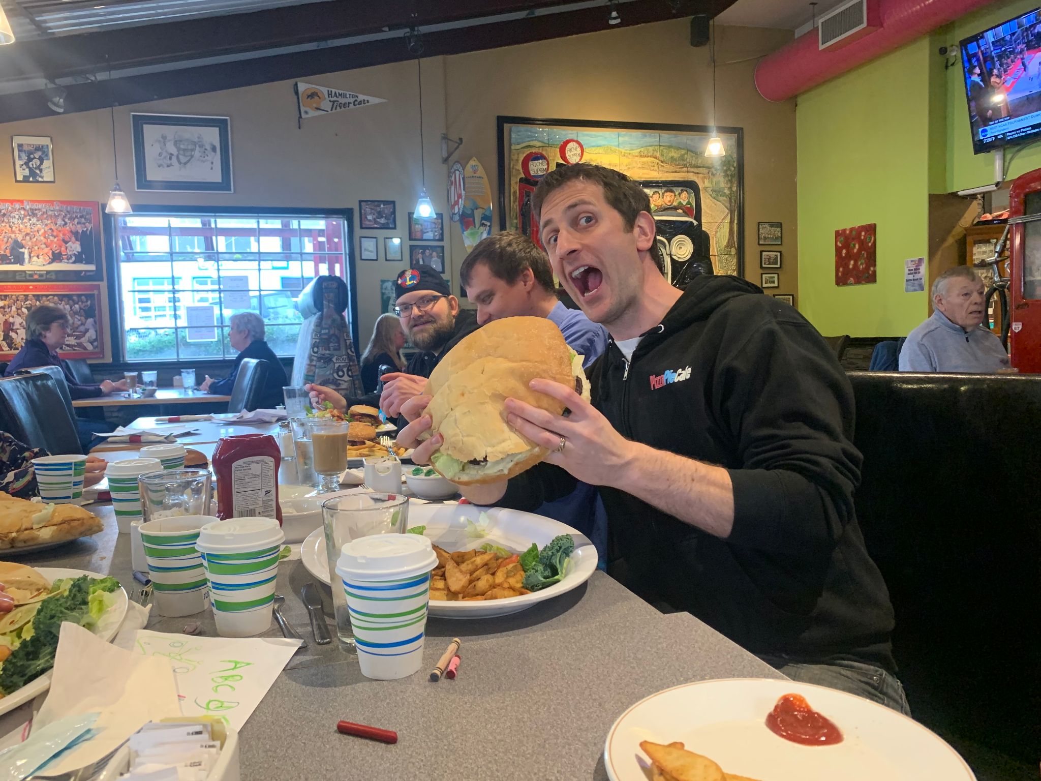 Mike Nelson about to take a bite from a massive hamburger
