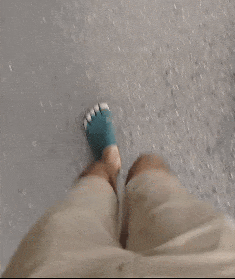 GIF of man walking in green Vibram five-finger shoes